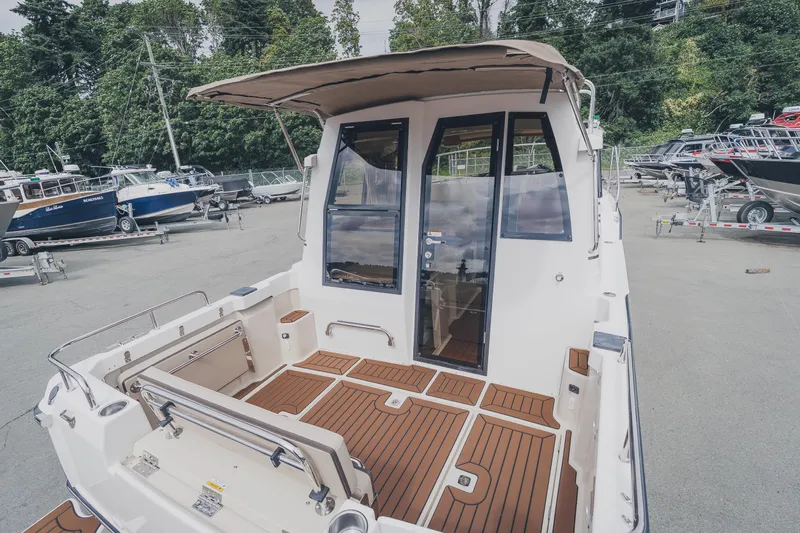  Yacht Photos Pics 2025 Ranger Tugs R-23 boat with teak deck, docked outdoors.