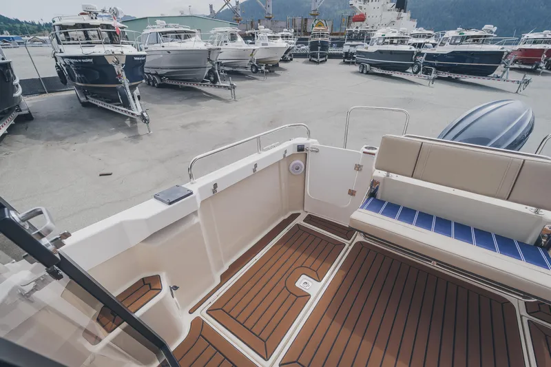  Yacht Photos Pics 2025 Ranger Tugs R-23 boat interior with teak flooring at a marina.