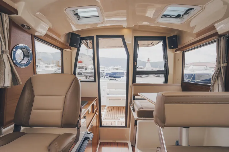  Yacht Photos Pics Interior of 2025 Ranger Tugs R-23 boat, featuring elegant seating and panoramic windows.