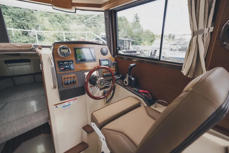  Yacht Photos Pics 2025 Ranger Tugs R-23 boat interior with modern dashboard and steering wheel.