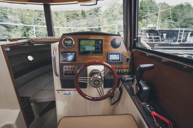  Yacht Photos Pics Helm of 2025 Ranger Tugs R-23 boat with navigation controls and steering wheel.