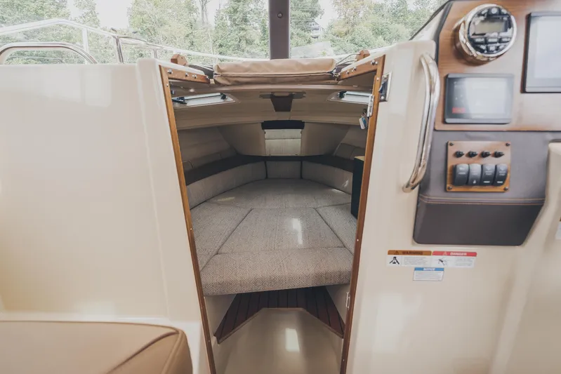  Yacht Photos Pics 2025 Ranger Tugs R-23 cabin interior with cozy seating and control panel.