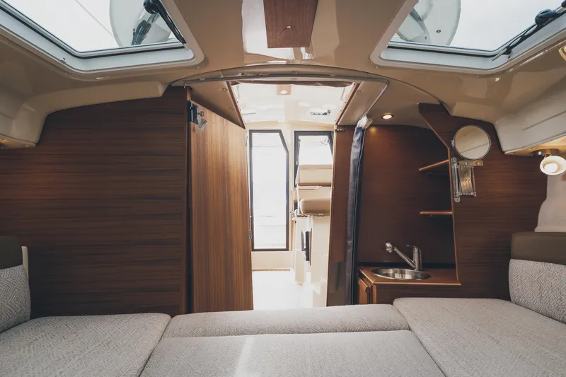  Yacht Photos Pics Interior of 2025 Ranger Tugs R-23 boat with wood finish and compact kitchenette.