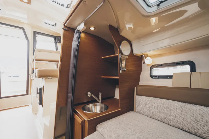  Yacht Photos Pics Interior of 2025 Ranger Tugs R-23 boat with cozy seating and compact sink area.