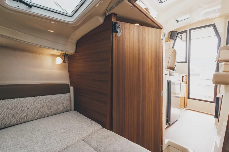  Yacht Photos Pics 2025 Ranger Tugs R-23 interior cabin with cozy bed and modern wood finish.