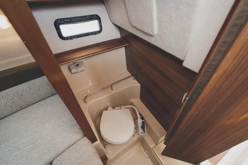  Yacht Photos Pics 2025 Ranger Tugs R-23 boat interior with compact bathroom and toilet.
