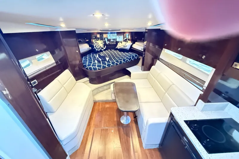  Yacht Photos Pics Luxurious interior of 2015 Sea Ray 350 Sundancer yacht with modern seating and elegant design.