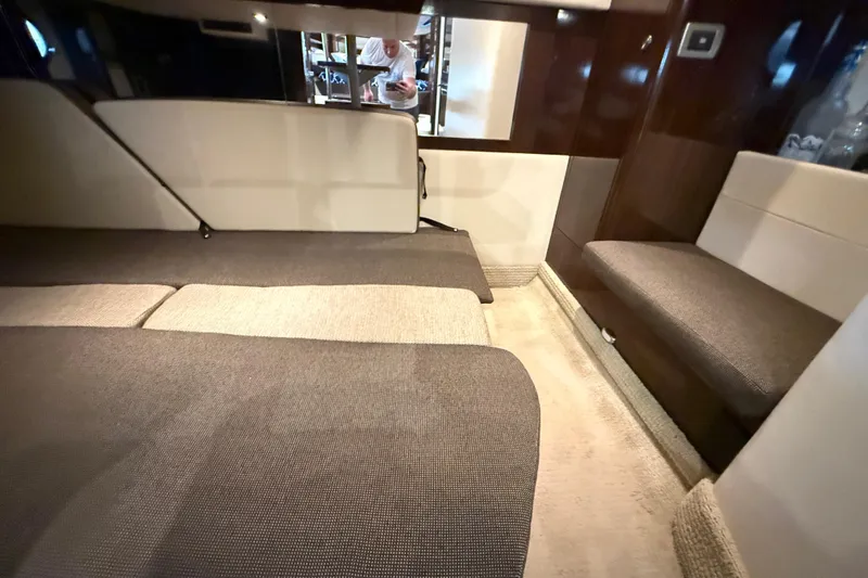  Yacht Photos Pics Interior cabin of 2015 Sea Ray 350 Sundancer with beige and brown seating.