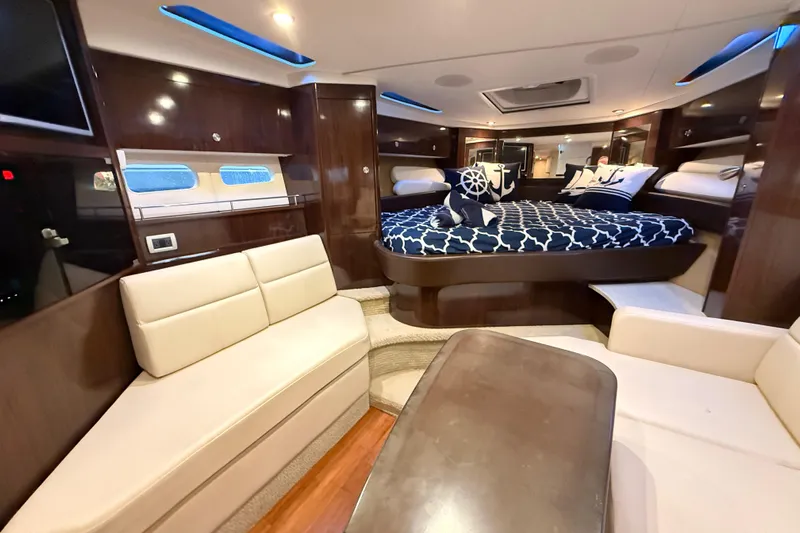  Yacht Photos Pics Luxurious interior of 2015 Sea Ray 350 Sundancer yacht with elegant seating and bedding.