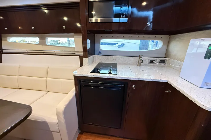  Yacht Photos Pics Luxurious interior of 2015 Sea Ray 350 Sundancer yacht with modern kitchen amenities.