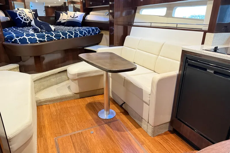  Yacht Photos Pics Luxurious interior of 2015 Sea Ray 350 Sundancer yacht with cozy seating and elegant decor.