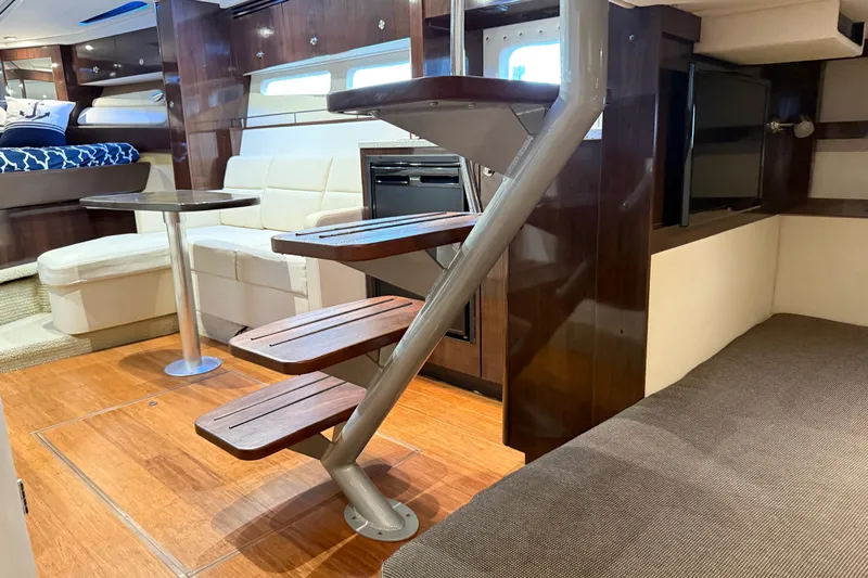  Yacht Photos Pics 2015 Sea Ray 350 Sundancer interior with modern wood finishes and cozy seating area.