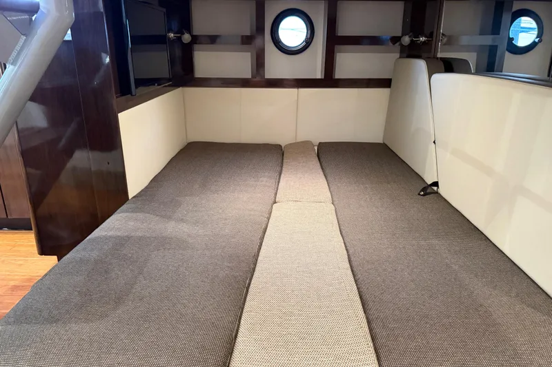  Yacht Photos Pics Interior cabin of 2015 Sea Ray 350 Sundancer with cozy seating and porthole window.
