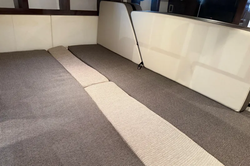  Yacht Photos Pics Interior cabin of 2015 Sea Ray 350 Sundancer with cushioned seating.