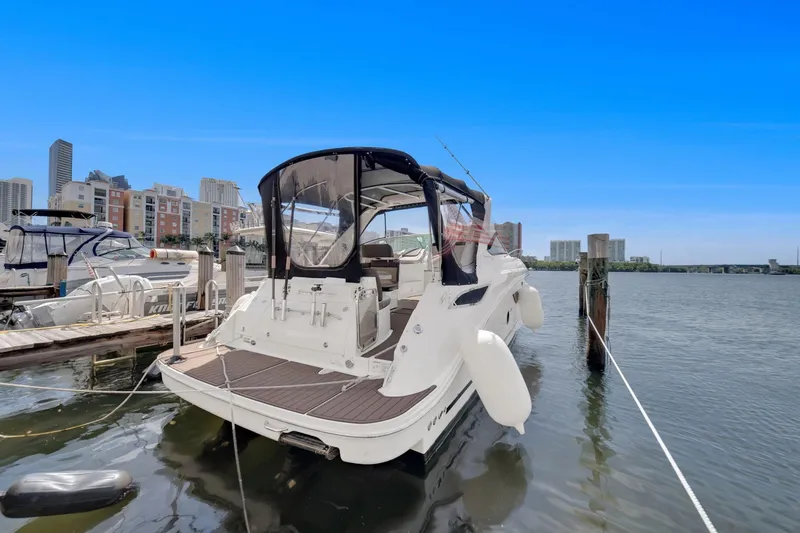  Yacht Photos Pics 2015 Sea Ray 350 Sundancer docked in a marina with city skyline backdrop.