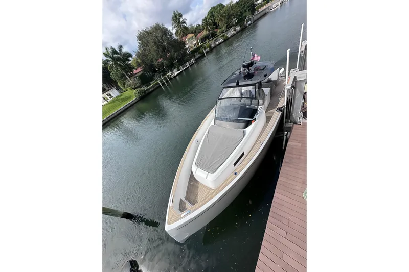No Name Yacht Photos Pics 2024 Pardo Yachts P38 docked on a serene canal with lush greenery.