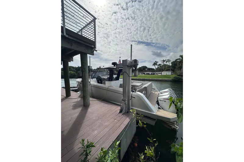 No Name Yacht Photos Pics 2024 Pardo Yachts P38 docked by a wooden pier under a cloudy sky.