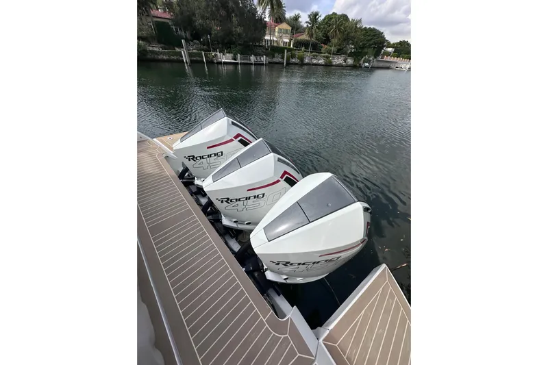 No Name Yacht Photos Pics Triple outboard engines on 2024 Pardo Yachts P38, docked by a serene waterfront.