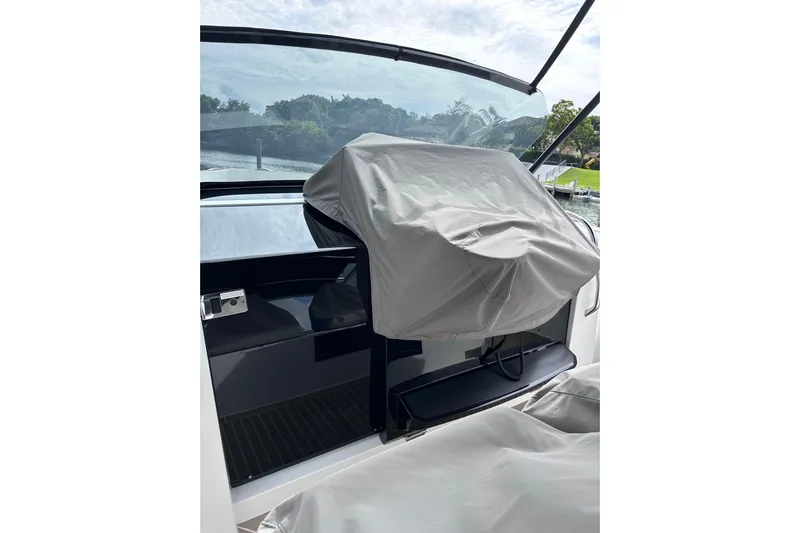 No Name Yacht Photos Pics 2024 Pardo Yachts P38 cockpit with covered helm station, sleek design, and waterfront view.