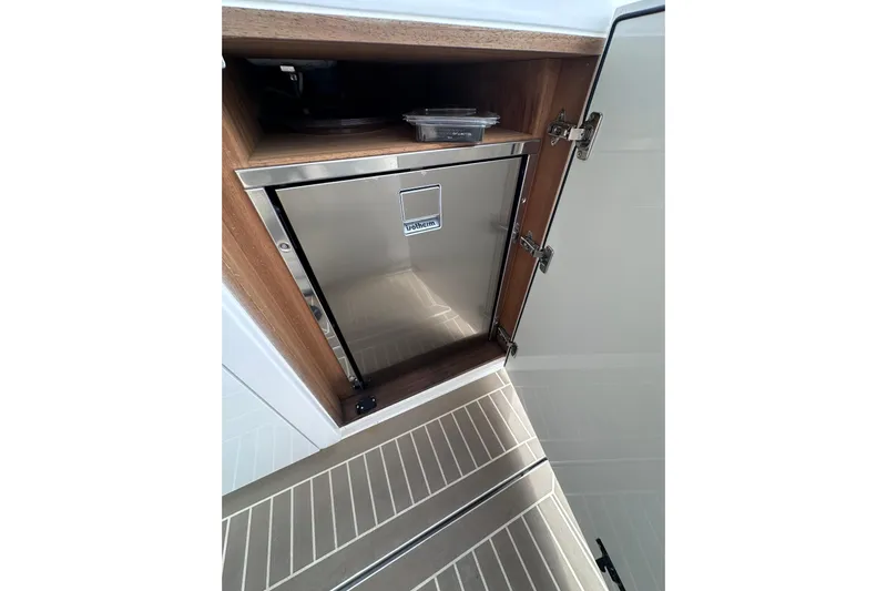 No Name Yacht Photos Pics Stainless steel fridge in 2024 Pardo Yachts P38 interior, open cabinet view.