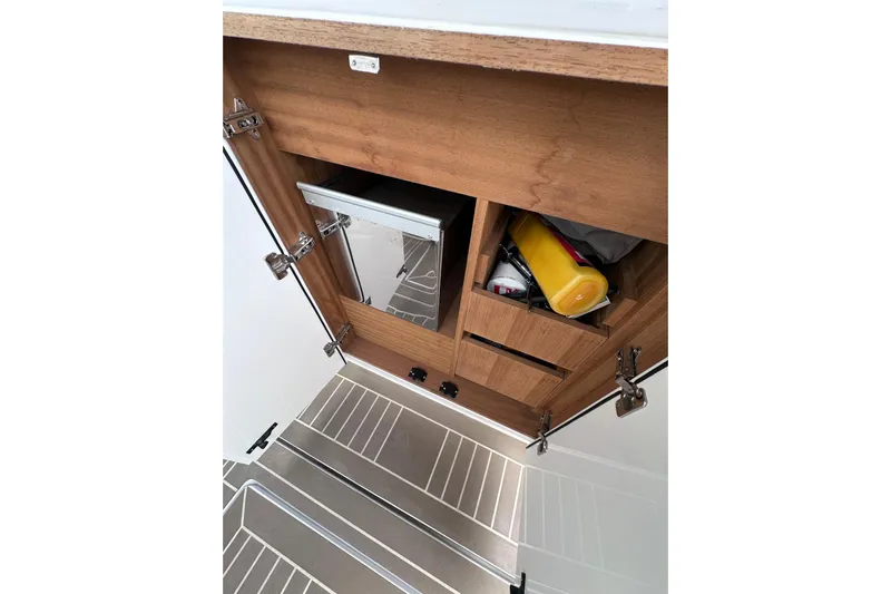 No Name Yacht Photos Pics 2024 Pardo Yachts P38 interior storage with wooden cabinetry and stainless steel flooring.