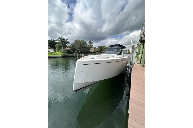 No Name Yacht Photos Pics 2024 Pardo Yachts P38 docked on a serene waterfront under cloudy skies.