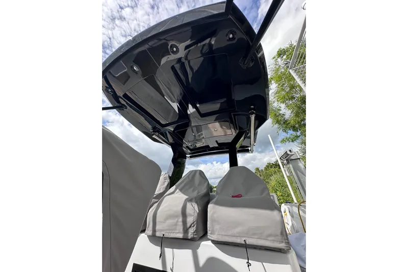 No Name Yacht Photos Pics 2024 Pardo Yachts P38 boat canopy and covered seats under a cloudy sky.