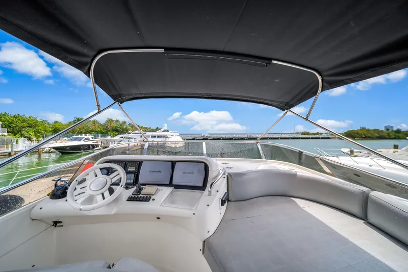  Yacht Photos Pics 2006 Azimut FLY 55 yacht cockpit with steering wheel and navigation screens, docked at marina.