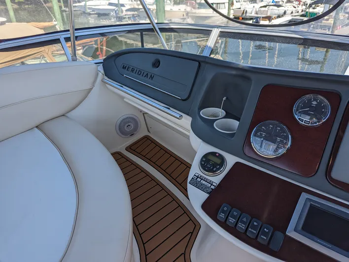 Lady C Yacht Photos Pics Interior of a 2011 Meridian 341 Sedan yacht, featuring dashboard controls and seating.
