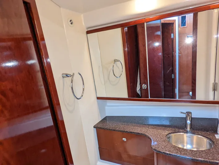 Lady C Yacht Photos Pics Luxurious bathroom in 2011 Meridian 341 Sedan yacht with wood accents and modern fixtures.