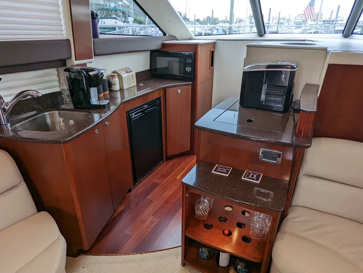Lady C Yacht Photos Pics Luxurious 2011 Meridian 341 Sedan yacht interior with kitchenette and wine storage.