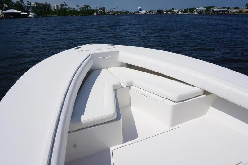 Past Time Yacht Photos Pics 2012 Regulator 32 Forward Seating boat with white cushioned seats on calm water.