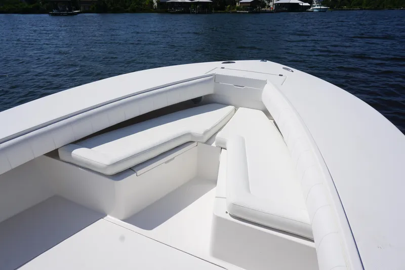 Past Time Yacht Photos Pics 2012 Regulator 32 Forward Seating boat with white cushioned seats on calm water.