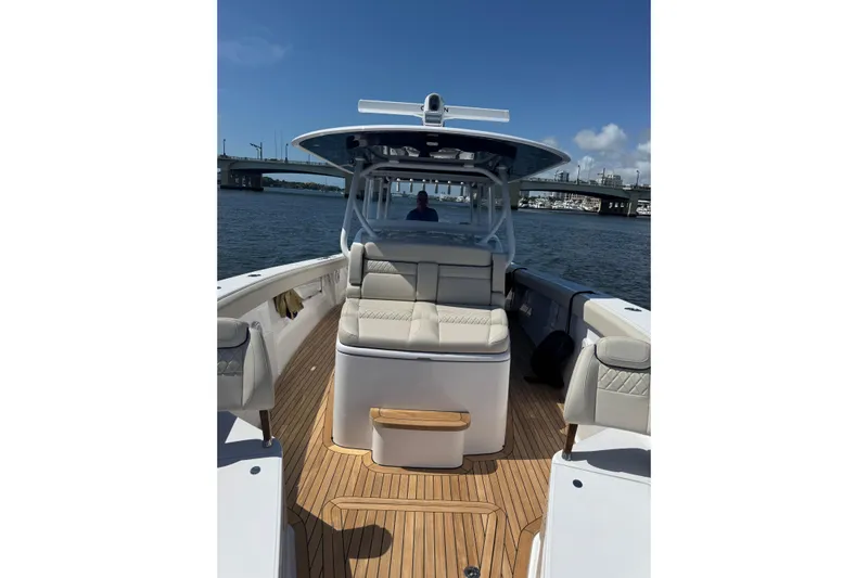 Madnic Yacht Photos Pics 2025 Jupiter 43 boat with sleek seating and wooden deck on a sunny day.