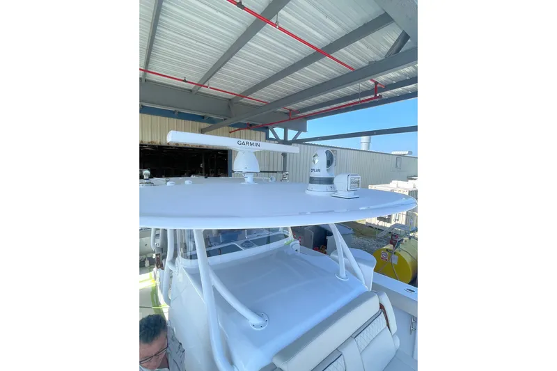 Madnic Yacht Photos Pics 2025 Jupiter 43 boat with Garmin radar and FLIR camera under a metal roof.