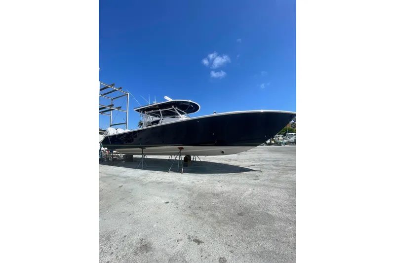 Madnic Yacht Photos Pics 2025 Jupiter 43 boat on dry dock under clear blue sky.