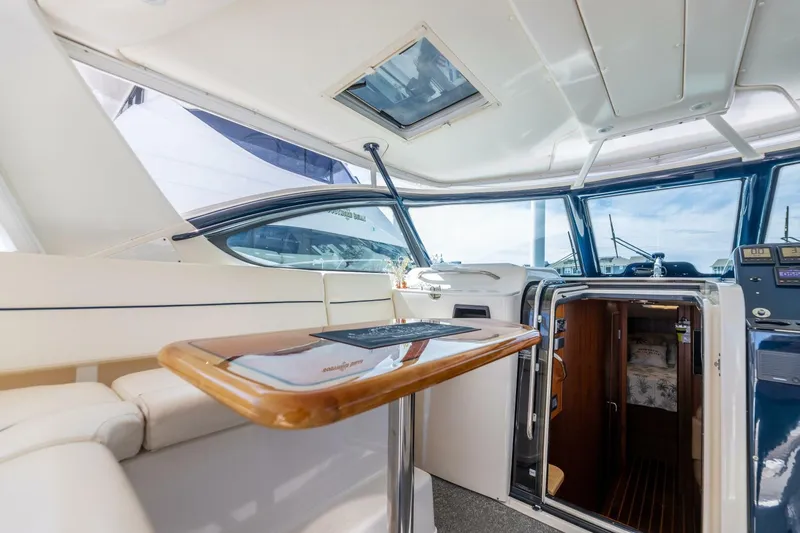 Sweet & Salty Yacht Photos Pics Interior of 2004 Tiara Yachts 38 Express with seating and table.