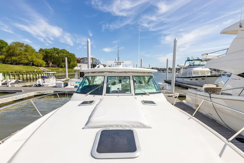 Sweet & Salty Yacht Photos Pics 2004 Tiara Yachts 38 Express docked at a marina on a sunny day.