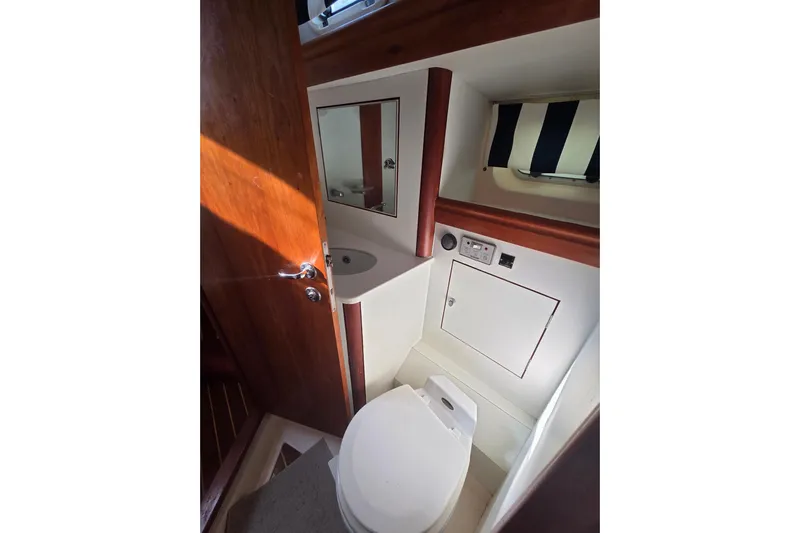 Pemaquid Yacht Photos Pics Bathroom interior of 1998 Oyster 485 Deck Saloon yacht, featuring toilet and sink.