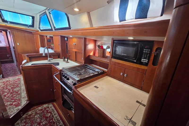 Pemaquid Yacht Photos Pics Interior of 1998 Oyster 485 Deck Saloon yacht, featuring a well-equipped kitchen area.