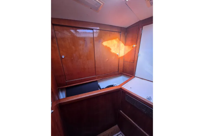 Pemaquid Yacht Photos Pics Interior of 1998 Oyster 485 Deck Saloon with wooden cabinetry and natural light.