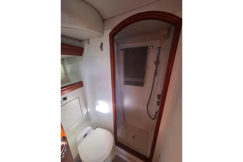 Pemaquid Yacht Photos Pics Bathroom interior of 1998 Oyster 485 Deck Saloon yacht, featuring shower and toilet.