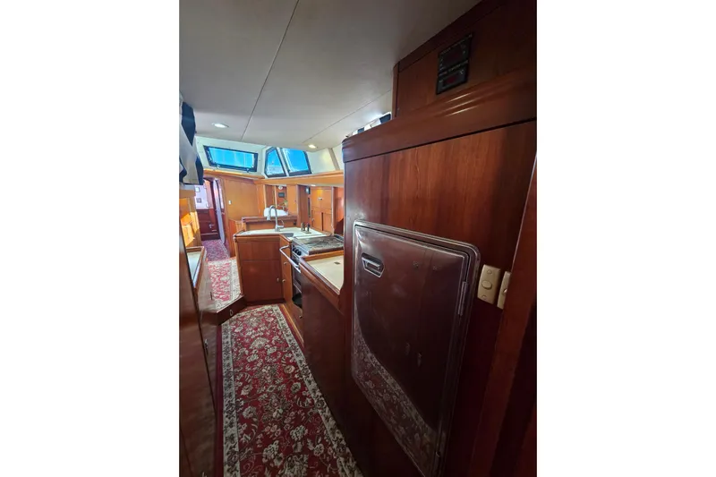 Pemaquid Yacht Photos Pics Interior of 1998 Oyster 485 Deck Saloon yacht with wood finish and carpeted floor.
