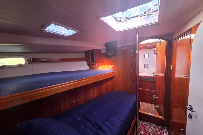 Pemaquid Yacht Photos Pics Interior of 1998 Oyster 485 Deck Saloon yacht with wooden finish and bunk beds.
