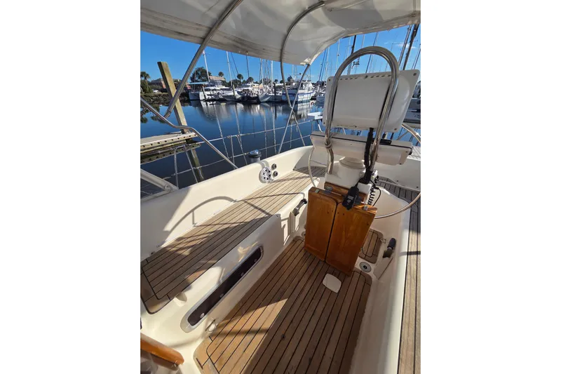 Pemaquid Yacht Photos Pics Cockpit of 1998 Oyster 485 Deck Saloon yacht with wooden flooring and steering wheel.