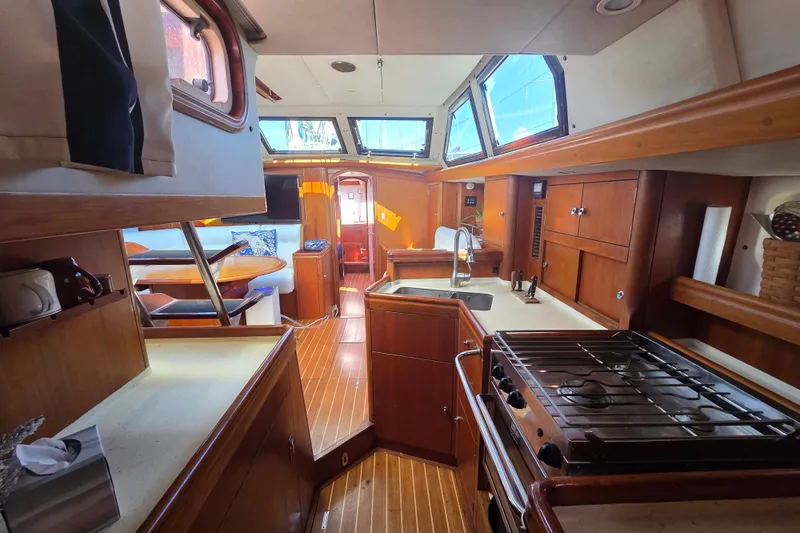 Pemaquid Yacht Photos Pics Interior of 1998 Oyster 485 Deck Saloon yacht with wood finish and modern amenities.