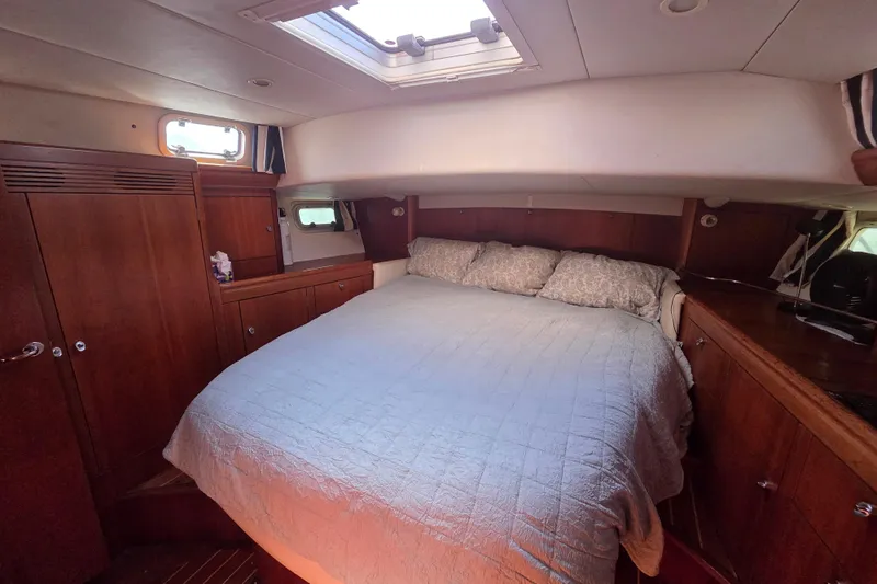 Pemaquid Yacht Photos Pics Luxurious cabin interior of 1998 Oyster 485 Deck Saloon yacht with cozy bedding.