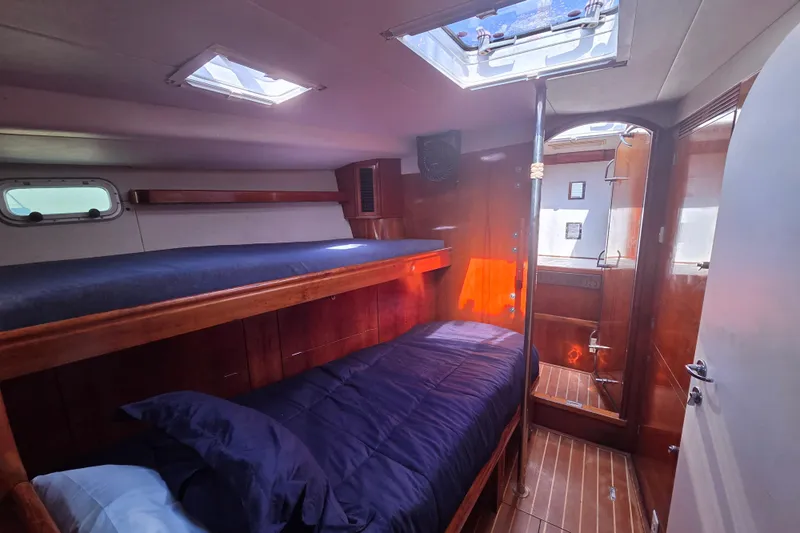 Pemaquid Yacht Photos Pics Interior of 1998 Oyster 485 Deck Saloon with wooden bunk beds and skylight.