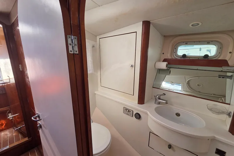 Pemaquid Yacht Photos Pics Bathroom interior of 1998 Oyster 485 Deck Saloon yacht, featuring sink and mirror.