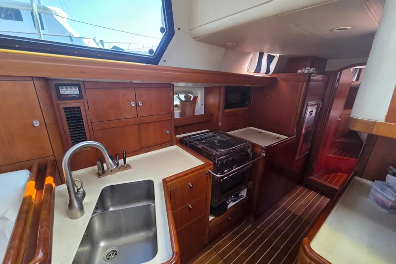 Pemaquid Yacht Photos Pics Luxurious 1998 Oyster 485 Deck Saloon yacht interior with modern kitchen amenities.